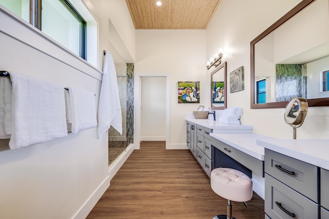 bathroom featuring wood ceiling, a towering ceiling, a shower, hardwood / wood-style floors, and vanity