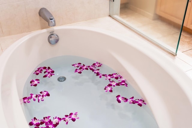 details with a bath and light tile flooring