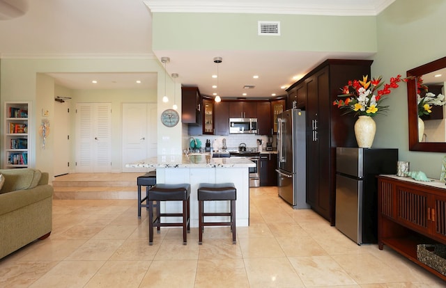 kitchen featuring light stone countertops, appliances with stainless steel finishes, backsplash, crown molding, and pendant lighting