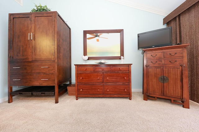 carpeted bedroom with lofted ceiling and ornamental molding