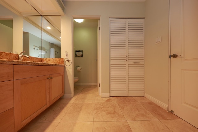 bathroom with tile patterned floors, vanity, and toilet