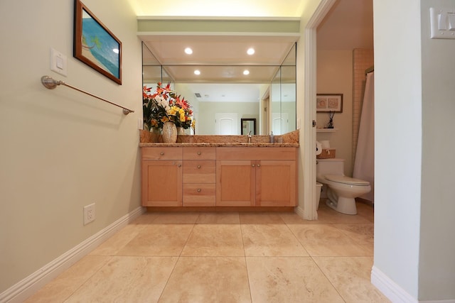 bathroom with tile patterned flooring, vanity, and toilet