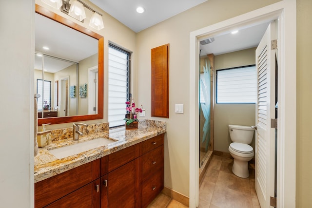 bathroom featuring tile patterned flooring, a shower, vanity, and toilet