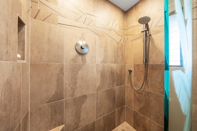 bathroom with tiled shower