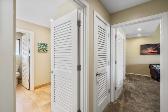 hallway with light colored carpet