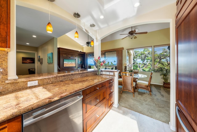 kitchen with light carpet, stainless steel dishwasher, light stone counters, ceiling fan, and hanging light fixtures