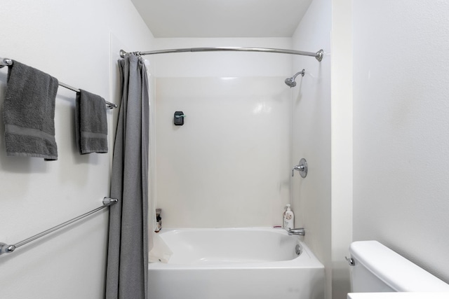 bathroom featuring shower / bath combo and toilet