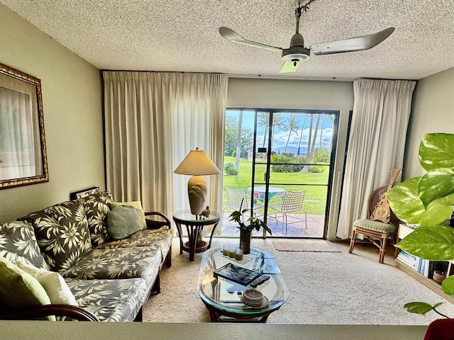 carpeted living room featuring a textured ceiling and ceiling fan