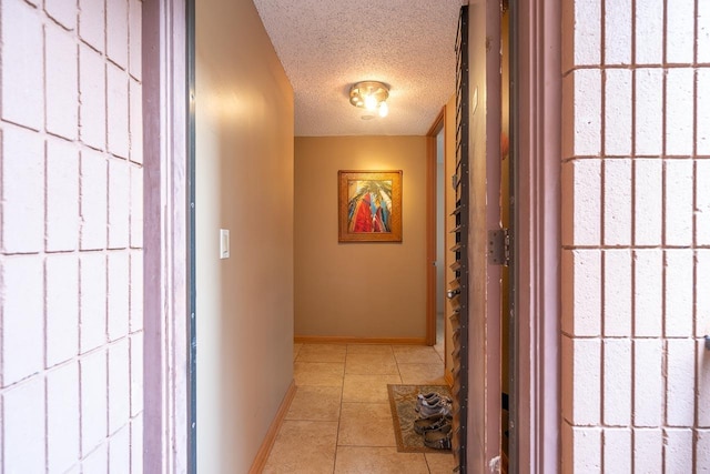 30 Hauoli St Unit 212, Wailuku, HI 96793 - corridor with a textured ceiling, tile patterned floors, and baseboards