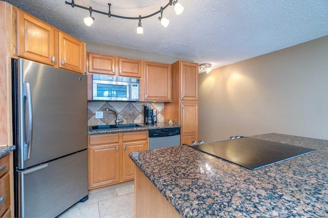 30 Hauoli St Unit 212, Wailuku, HI 96793 - kitchen featuring appliances with stainless steel finishes, a sink, backsplash, a textured ceiling, and light tile patterned floors