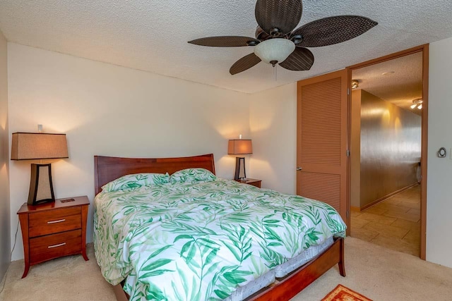 30 Hauoli St Unit 212, Wailuku, HI 96793 - bedroom with light carpet, a textured ceiling, a closet, and ceiling fan