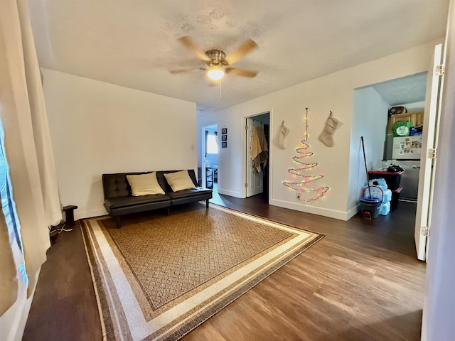 sitting room featuring dark hardwood / wood-style floors and ceiling fan