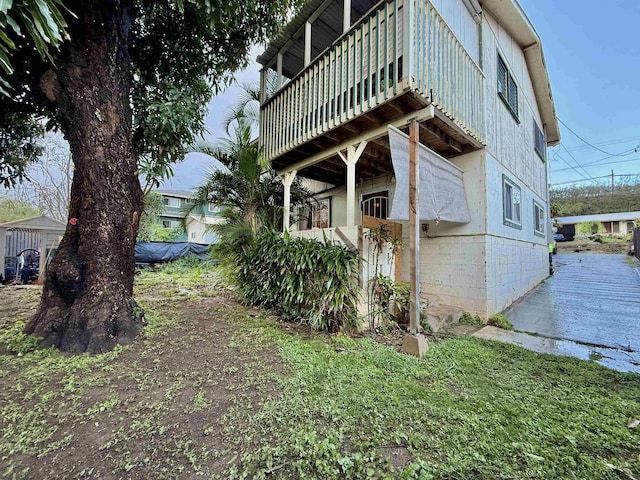 view of home's exterior with a balcony