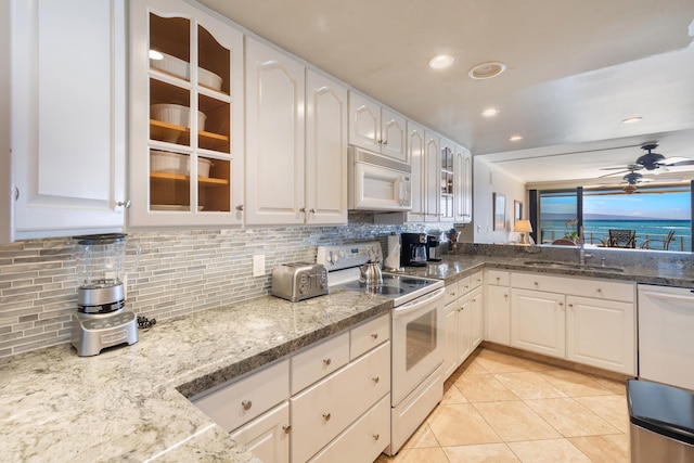 4401 Lower Honoapiilani Rd Unit A-103, Lahaina, HI 96761 - kitchen with white appliances, a sink, tasteful backsplash, glass insert cabinets, and a ceiling fan