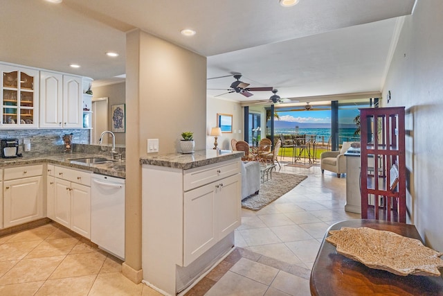 4401 Lower Honoapiilani Rd Unit A-103, Lahaina, HI 96761 - kitchen with white dishwasher, a sink, light tile patterned floors, ceiling fan, and decorative backsplash