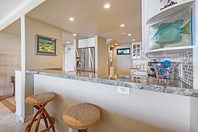 4401 Lower Honoapiilani Rd Unit A-103, Lahaina, HI 96761 - kitchen with stainless steel fridge with ice dispenser, recessed lighting, white cabinetry, light tile patterned floors, and decorative backsplash