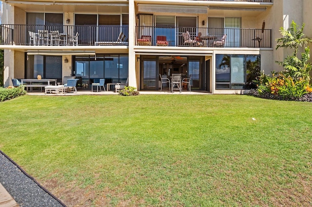 4401 Lower Honoapiilani Rd Unit A-103, Lahaina, HI 96761 - back of house with a balcony, a lawn, a patio area, and stucco siding
