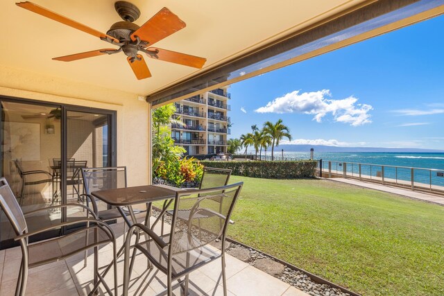 view of patio / terrace featuring a water view and ceiling fan