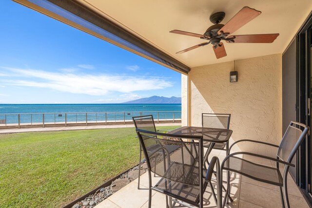 exterior space featuring a water and mountain view and ceiling fan