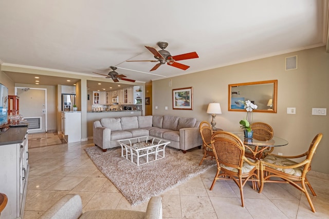 tiled living room with ceiling fan and crown molding