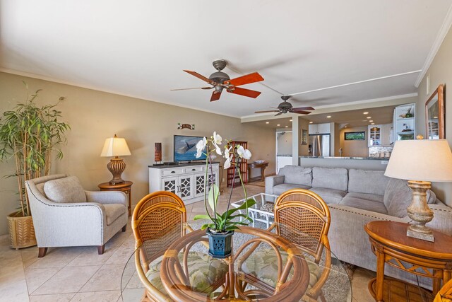 tiled living room with ceiling fan and ornamental molding