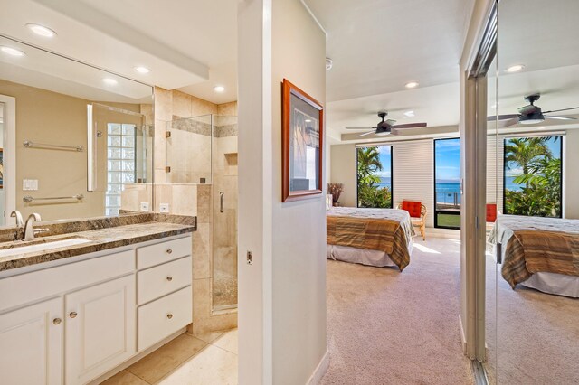 bathroom featuring vanity, a shower with door, tile patterned floors, and ceiling fan