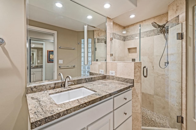 bathroom with vanity and an enclosed shower