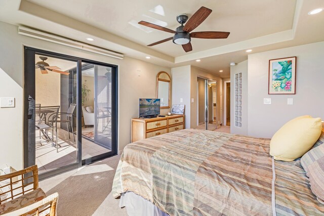 bedroom with access to outside, a tray ceiling, light carpet, and ceiling fan