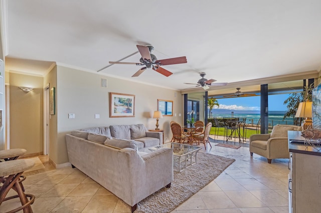 living room featuring ceiling fan, a water view, light tile patterned floors, and ornamental molding