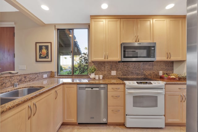 kitchen with stainless steel appliances, light brown cabinets, light stone countertops, and decorative backsplash