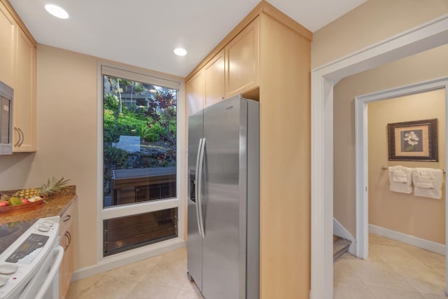 kitchen with recessed lighting, stove, light brown cabinetry, and stainless steel fridge with ice dispenser