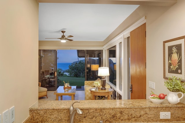 living area with a ceiling fan