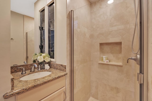 bathroom with a stall shower and vanity