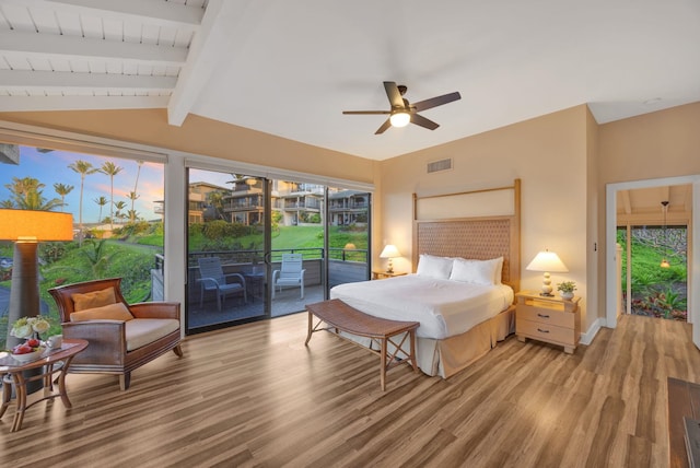 bedroom with baseboards, visible vents, wood finished floors, vaulted ceiling with beams, and access to outside