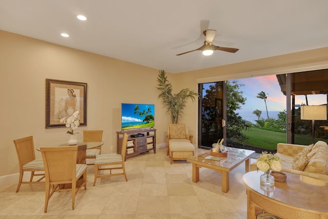 living area with recessed lighting, ceiling fan, baseboards, and light tile patterned floors