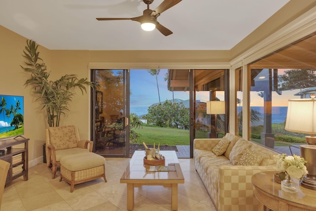 sunroom / solarium featuring ceiling fan