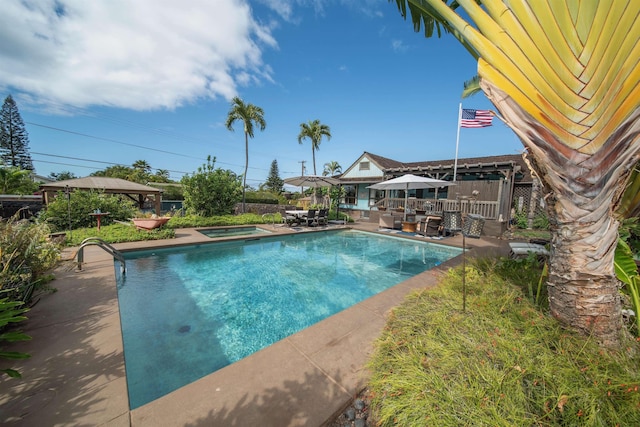 view of pool featuring an in ground hot tub and a patio