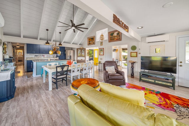 living room with ceiling fan, beamed ceiling, a wall mounted air conditioner, and light wood-type flooring