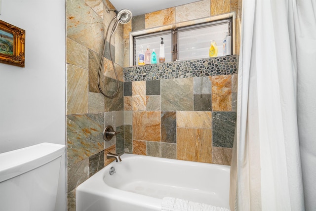 bathroom with shower / tub combo and toilet