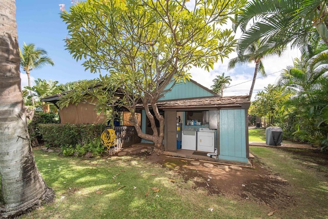 back of house with separate washer and dryer and electric water heater