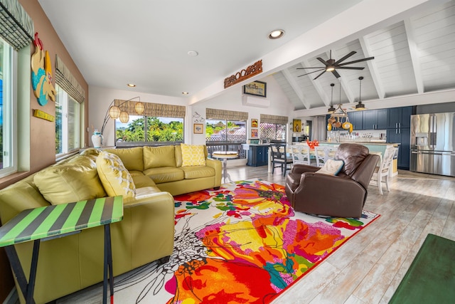 living room with lofted ceiling with beams, light hardwood / wood-style floors, and ceiling fan