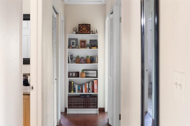 corridor featuring built in features and dark hardwood / wood-style flooring