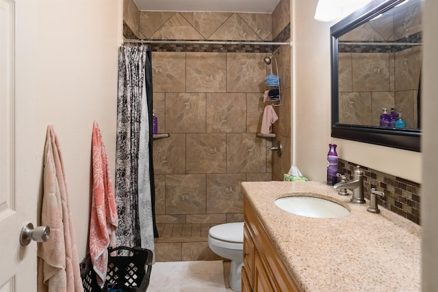 bathroom with tile patterned floors, curtained shower, vanity, and toilet