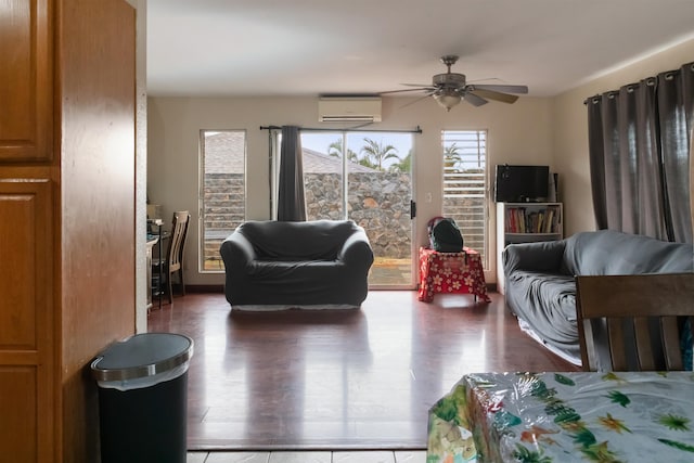 living room featuring ceiling fan, a wall unit AC, and dark hardwood / wood-style floors