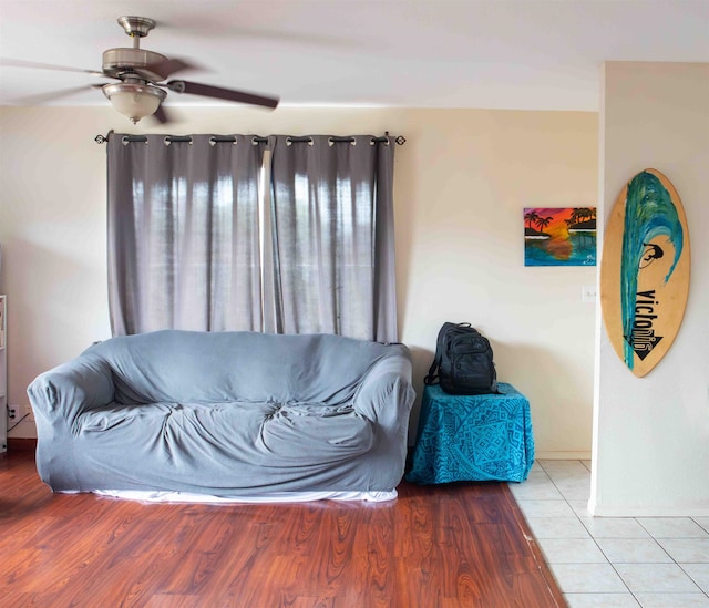 living room featuring ceiling fan and hardwood / wood-style flooring