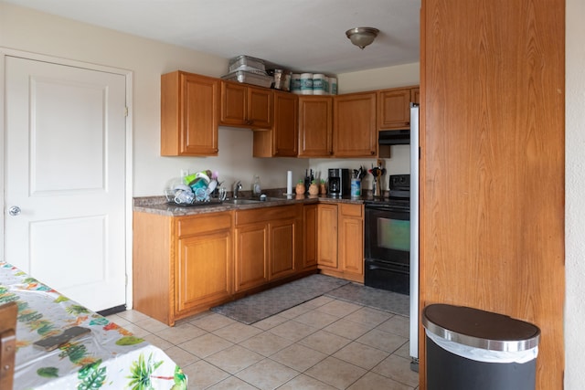 kitchen with sink, electric stove, and light tile patterned floors