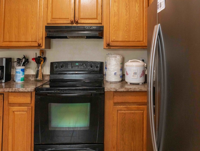 kitchen featuring stainless steel fridge and black range with electric stovetop