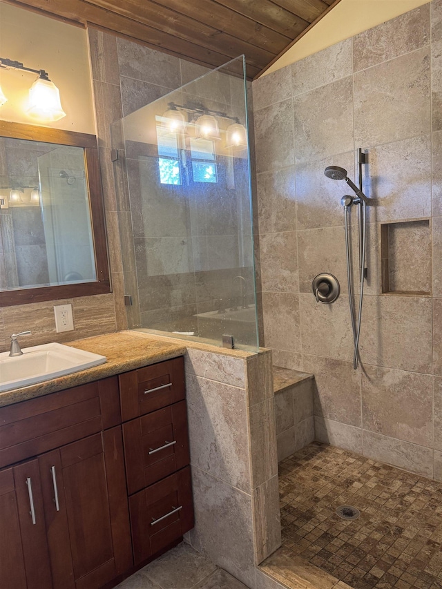 bathroom with vanity, a walk in shower, and lofted ceiling