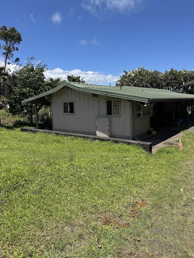 exterior space featuring a lawn and board and batten siding