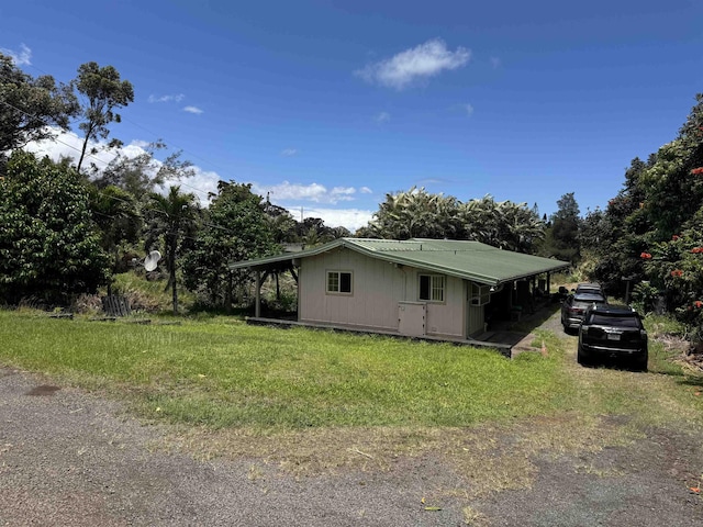 80 Alekanekelo Pl, Haiku, HI 96708 - view of home's exterior with a lawn and metal roof